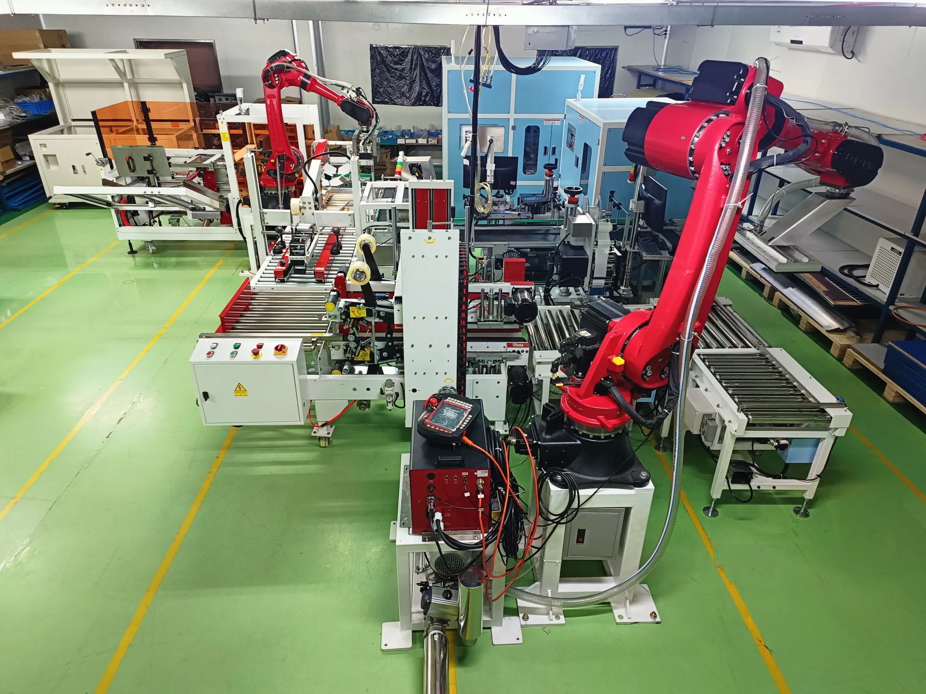 Robotic packaging and material handling line with conveyors and articulated arms